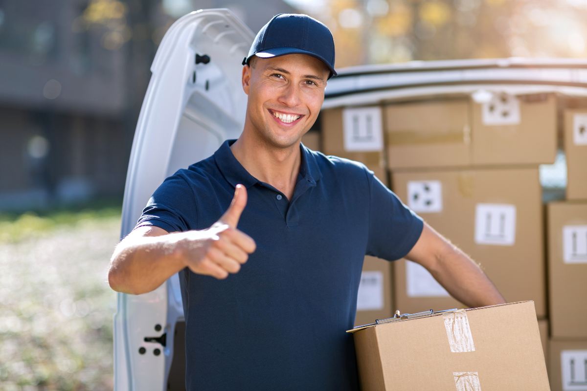 Courier moving packages in a warehouse staging area